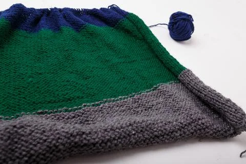Knitted clothing, accessory in process of making. Knitting needles and ball Stock Photos