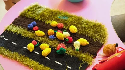 Knitted colorful fruit set on road mat. Textile toy for preschool education.. Stock Footage 333564000