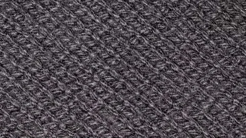 Knitted fabric made of black threads, rotating, turning, close-up macro 스톡 동영상 243987368