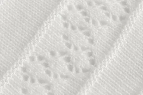Knitted fabric with an openwork pattern, handmade. Background, texture Stock Photos