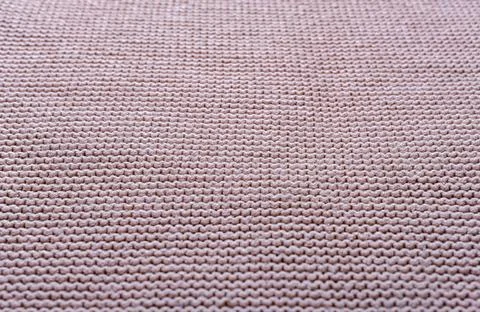 Knitted fabric texture. The pattern is clearly visible. Stock Photos