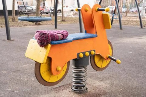 Knitted hat with pom-pom left on a spring-mounted ride-on toy 스톡 사진