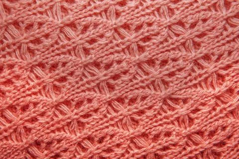 Knitted jersey background with a relief pattern Stock Photos