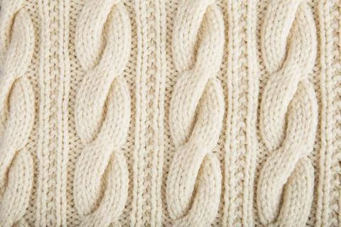 Knitted jersey background with a relief pattern Sweater or scarf texture l... Stock Photos