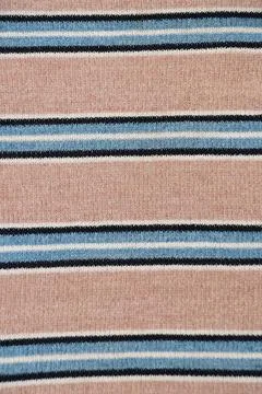 Knitted material closeup with striped pattern in beige, blue and black colors Stock Photos