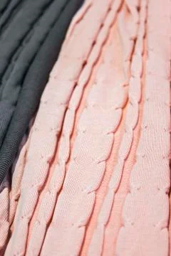 Knitted multi-colored plaids, blankets, knitted fabric textures in the store. Stock Photos