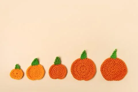 Knitted orange pumpkins Stock Photos