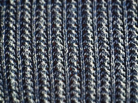 Knitted pattern of blue yarn. Lush machine or hand knitting. Warm wardrobe fo Fotos de archivo