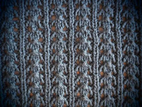 Knitted pattern of blue yarn. Lush machine or hand knitting. Warm wardrobe fo Stock Photos