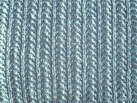Knitted pattern of blue yarn. Lush machine or hand knitting. Warm wardrobe fo Stock Photos