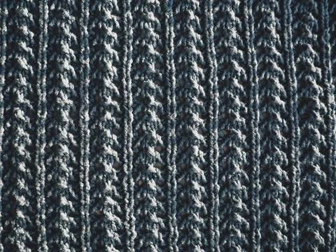 Knitted pattern of blue yarn. Lush machine or hand knitting. Warm wardrobe fo Fotos de archivo