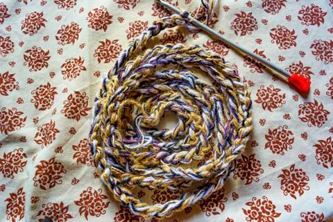 Knitted pattern of Circle spiral threads on fabric background Stock Photos