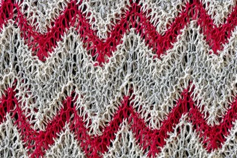 Knitted pattern in form of openwork zigzags crocheted with threads of 写真素材