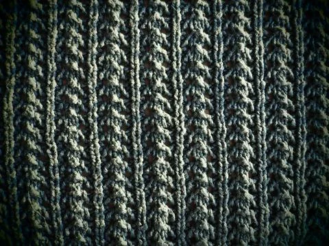 Knitted pattern of gray yarn. Lush machine or hand knitting. Warm wardrobe fo Stock Photos