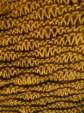 Knitted pattern of orange yarn. Lush machine or hand knitting. Warm wardrobe  Stock Photos