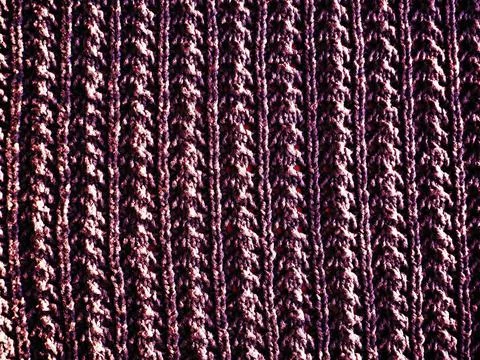 Knitted pattern of pink or red yarn. Lush machine or hand knitting. Warm ward Fotos de archivo