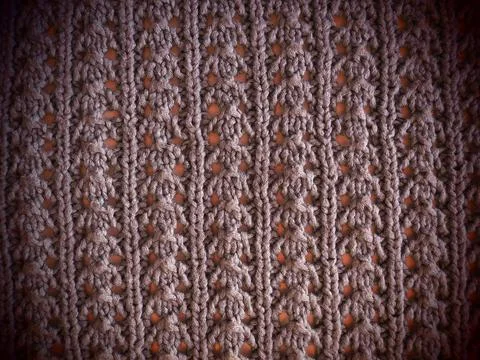 Knitted pattern of pink or red yarn. Lush machine or hand knitting. Warm ward Stock Photos