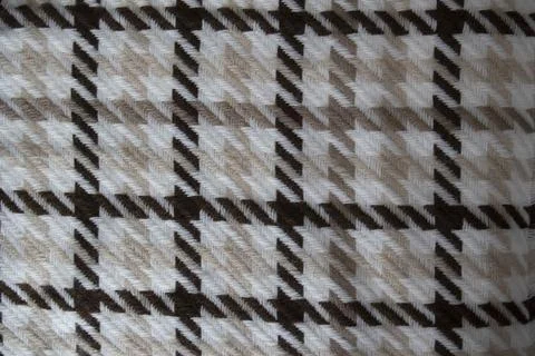 Knitted pattern of threads in brown, white and beige. Knitted background. K.. Stock Photos