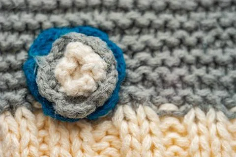Knitted pattern of threads in two colors and styles. Small flower on a scarf. Foto stock