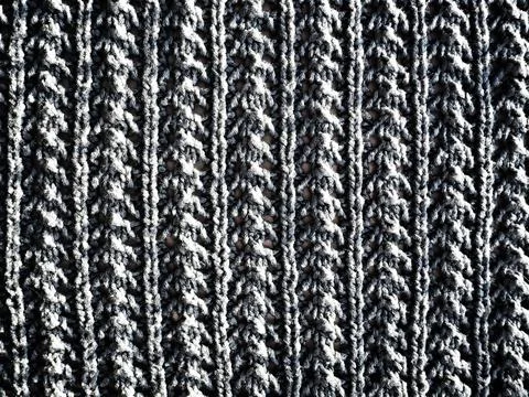 Knitted pattern of wool yarn. Lush machine or hand knitting. Warm wardrobe fo Stock Photos