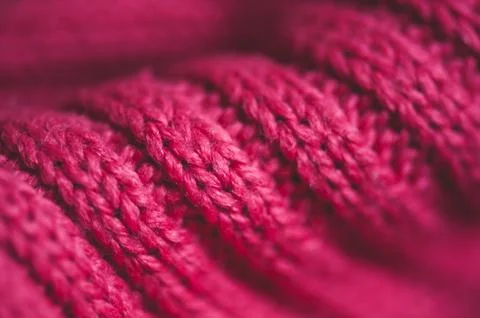 Knitted pink sweater with braid pattern close up. Winter season. Selective fo Stock-Fotos