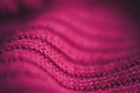 Knitted pink sweater with braid pattern close up. Winter season. Selective fo Stock-Fotos