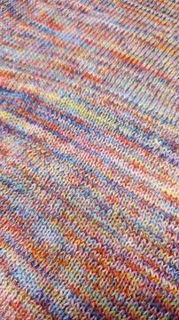 Knitted product from colored threads. Ready-made handmade women's sweater. Фото