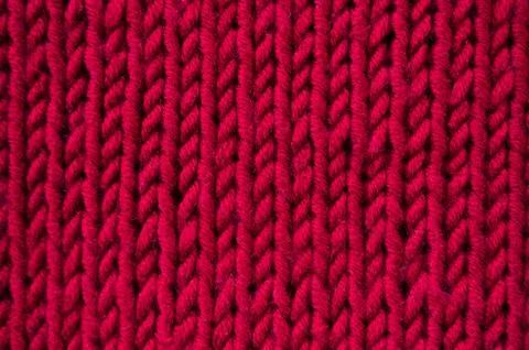 Knitted red canvas background closeup Stock Photos