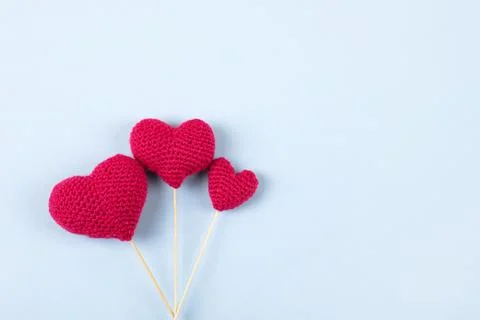 Knitted red hearts Stock Photos