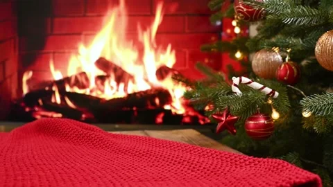 Knitted red plaid against the background of a decorated Christmas tree and a Stock Footage 220131082