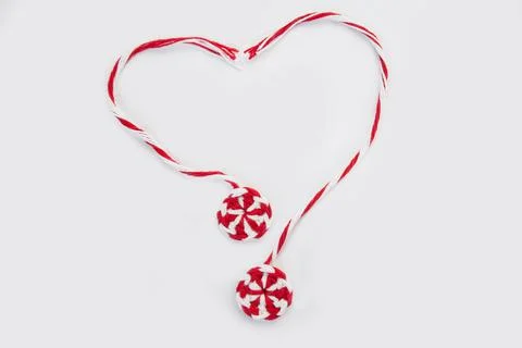 Knitted red white round candy caramel two pieces laid out in shape of heart o Stock Photos