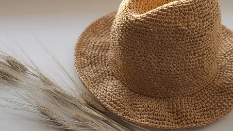 Knitted summer hat with fields from the sun of paper raffia Stock Footage 104357908