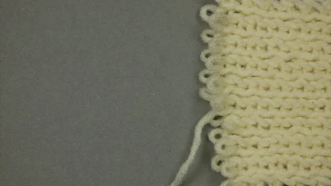 Knitted surface. Thread knits loops forming a background. Stop motion Stock Footage 125638093