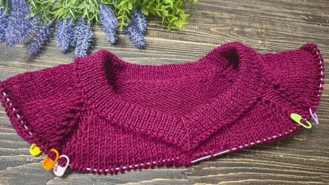 Knitted sweater collar in progress, using knitting needles and stitch markers Stock Photos