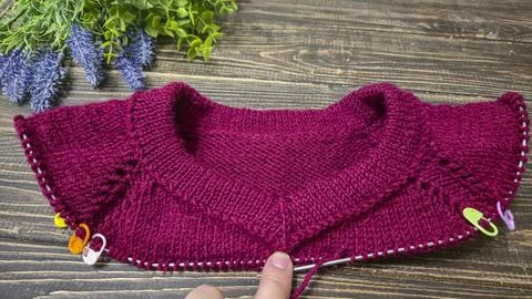 Knitted sweater collar in progress, using knitting needles and stitch markers Stock Photos