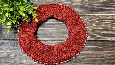Knitted sweater collar in progress, using knitting needles and stitch markers Stock Photos
