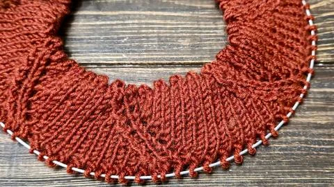 Knitted sweater collar in progress, using knitting needles and stitch markers Stock Photos