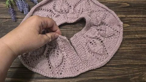 Knitted sweater collar in progress, using knitting needles and stitch markers Stock Photos