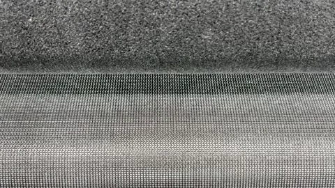 The knitted textile material comes out of the knitting machine Stock Footage 316310276