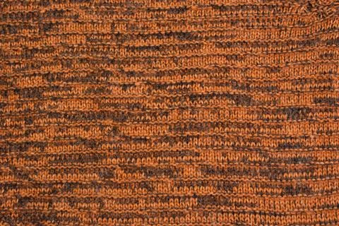 Knitted texture background orange top view flat Stock Photos