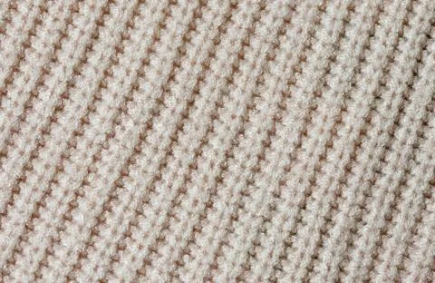 Knitted texture of beige yarn Stock Photos