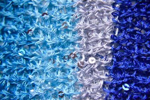 Knitted texture of fabric with sequins Stock Photos