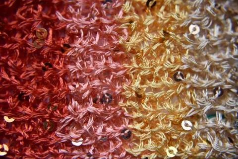 Knitted texture of fabric with sequins Stock Photos