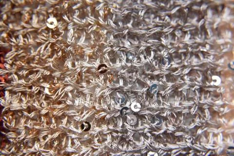 Knitted texture of fabric with sequins Stock Photos