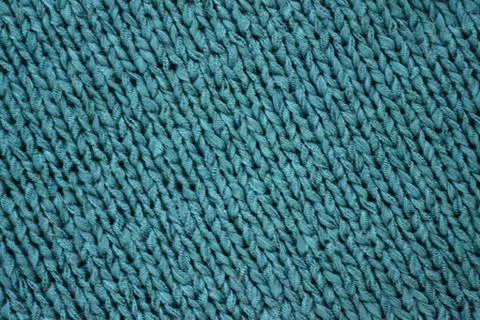 Knitted texture pattern in green-blue tones. Fashionable concept. Stock Photos