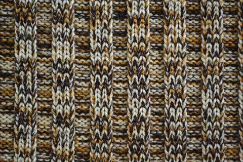Knitted texture pattern melange in dark brown tones. Fashionable concept. Stock Photos