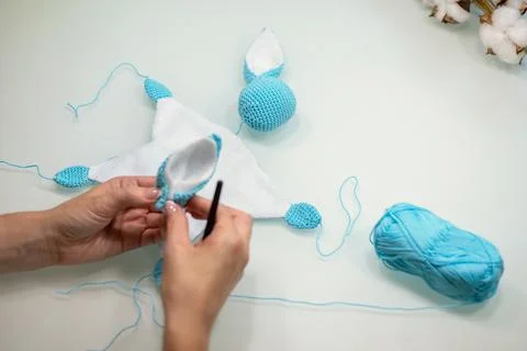 Knitted toy bunny in the process of making with your own hands Stock Photos