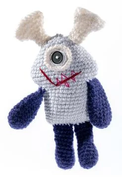 Knitted wool alien on a white background Stock Photos