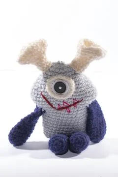 Knitted wool alien on a white background Stock Photos