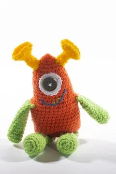 Knitted wool alien on a white background Stock Photos